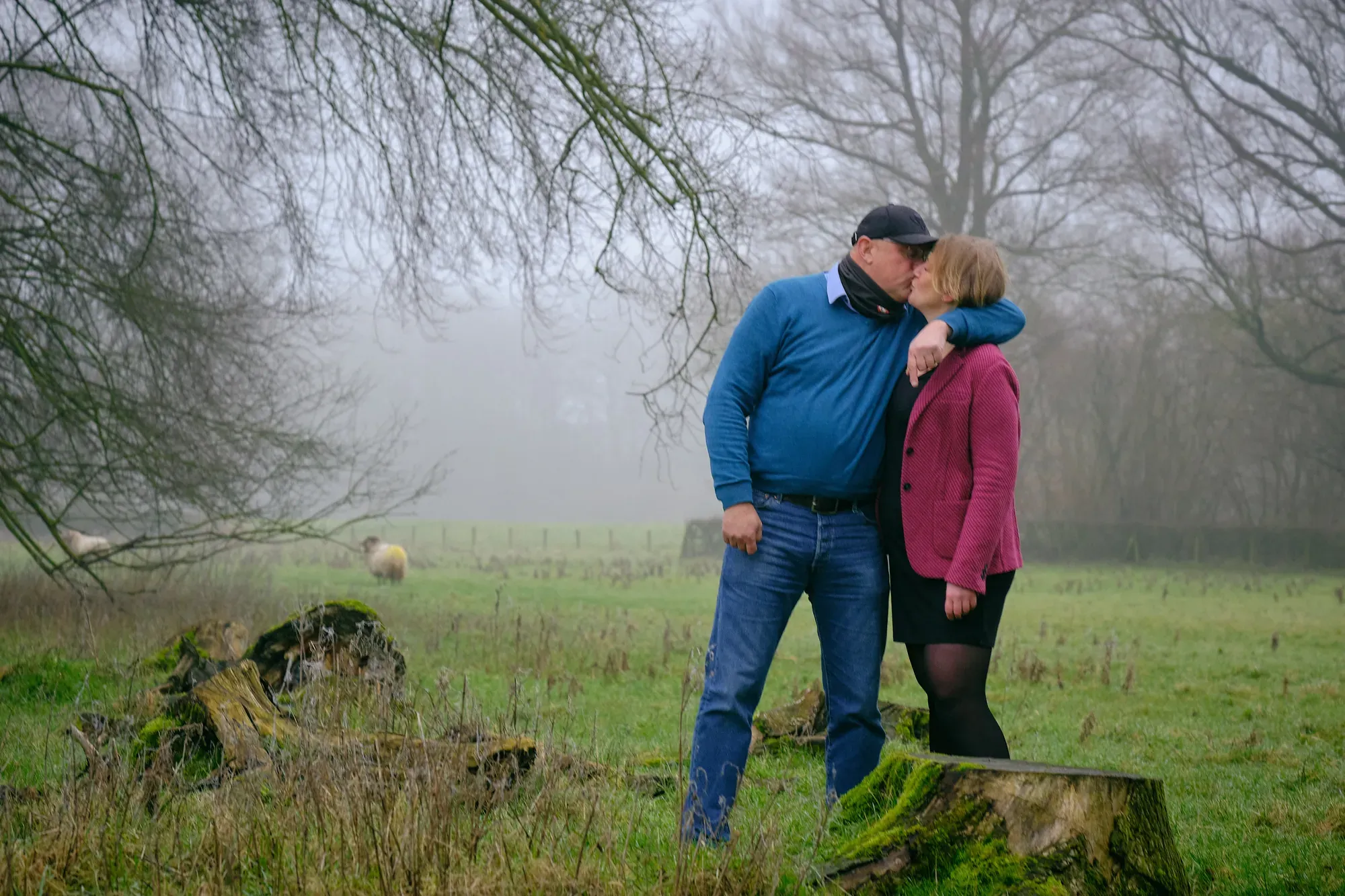 Stel staat samen in de mist op een grasveld in het Westerpark in januari